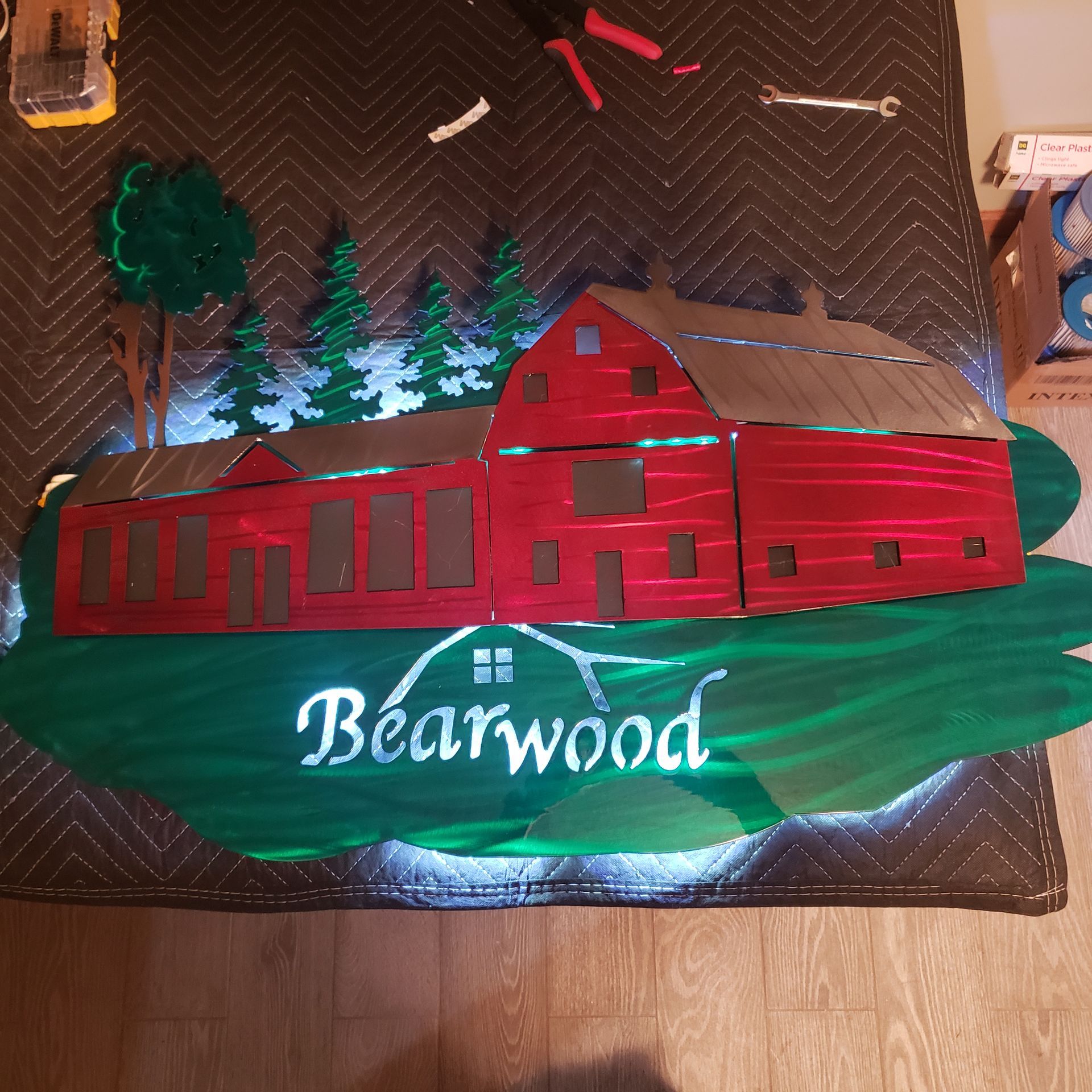 Metal barn sign with trees and 