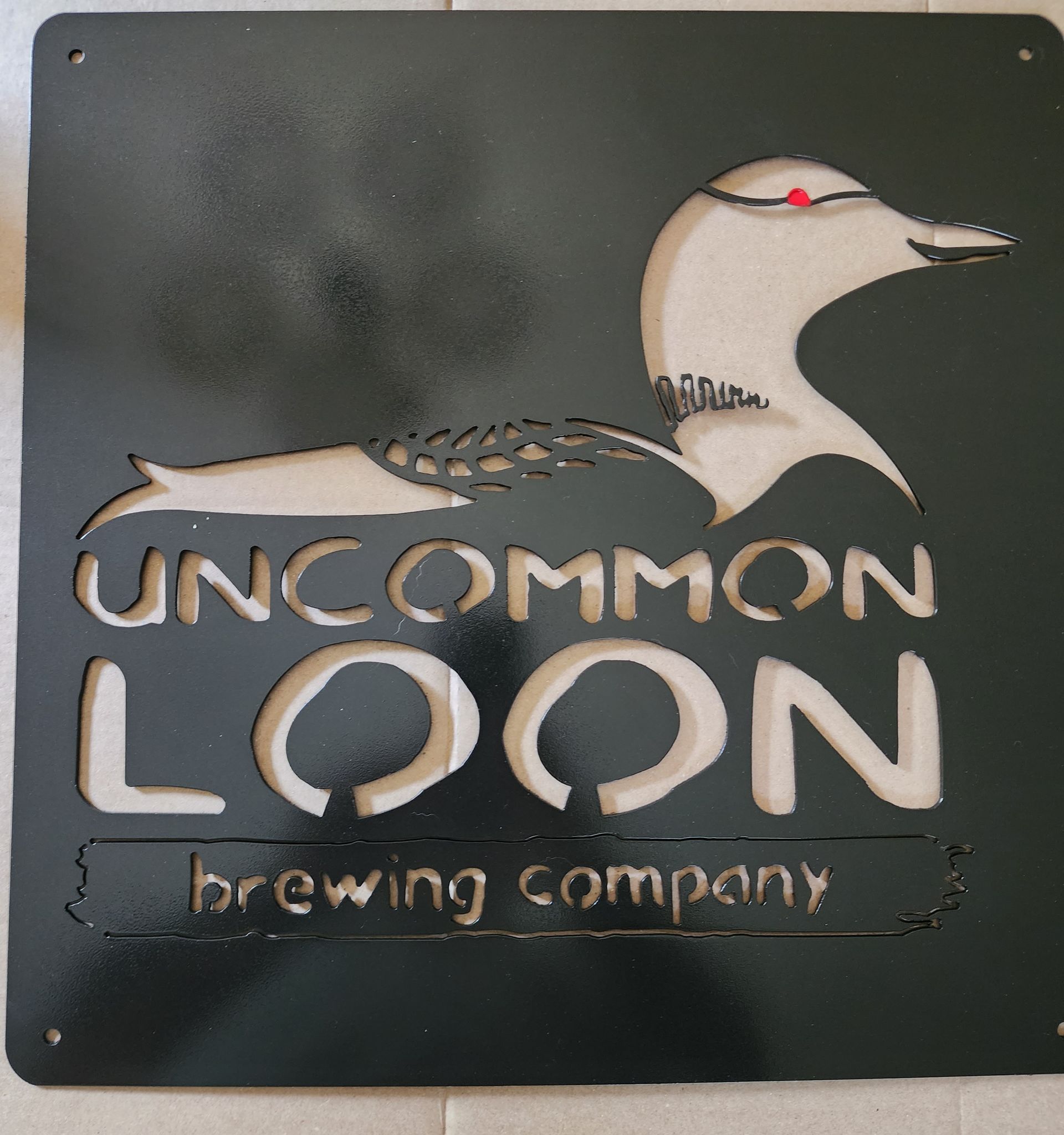 Black metal sign of a loon and 