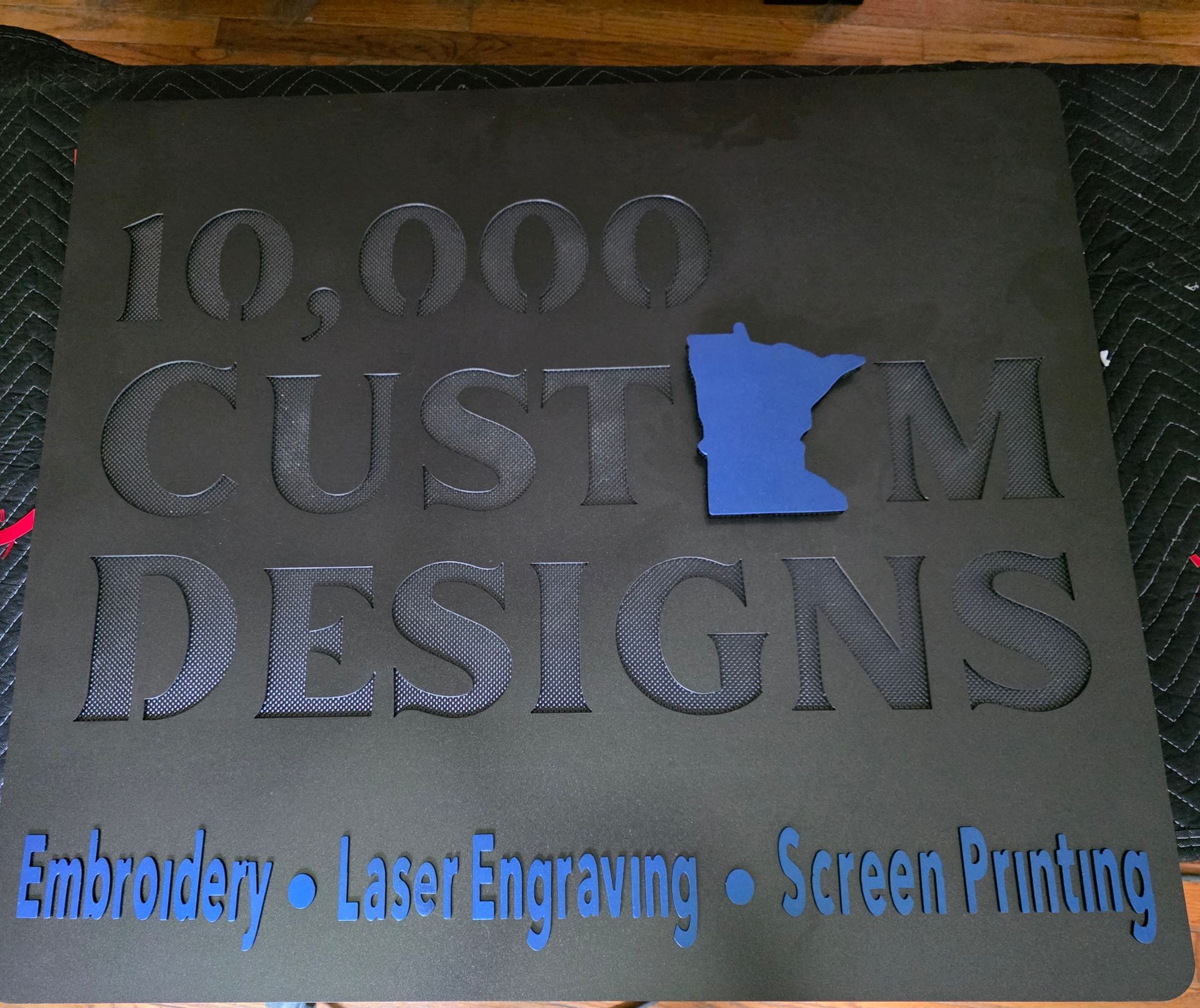 Black sign with raised lettering for 