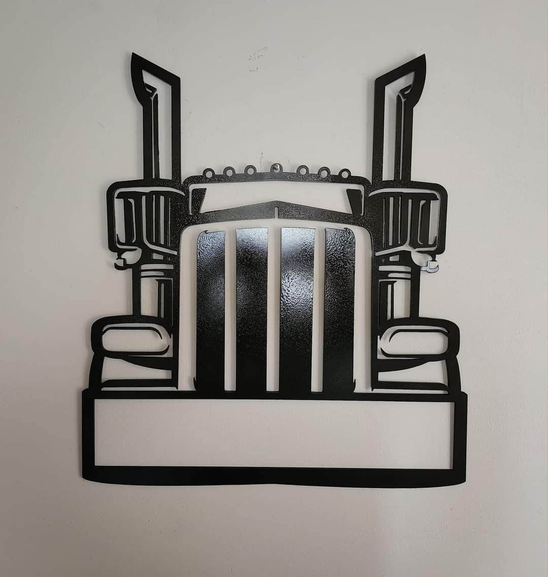 Black metal cutout of a semi-truck front on a white background.