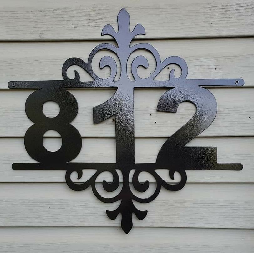 Black metal house number sign displaying 