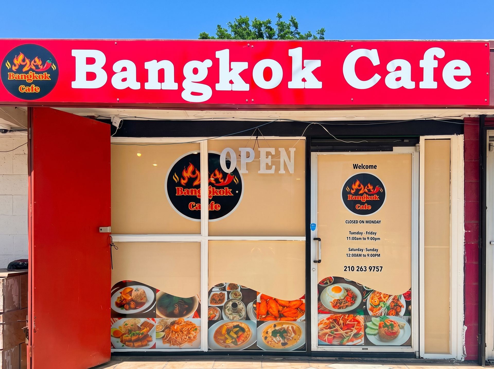 Bangkok Cafe storefront with red sign, open door, and food photos in the windows