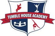 The logo for the tumble house academy is a shield with a red ribbon.