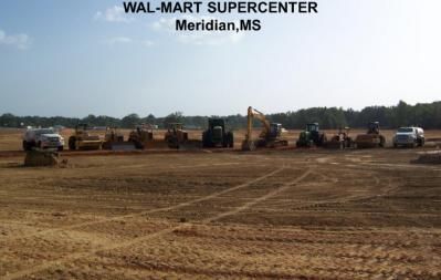 Construction site of a Wal-Mart Supercenter in Meridian, MS, with heavy machinery on a cleared lot.