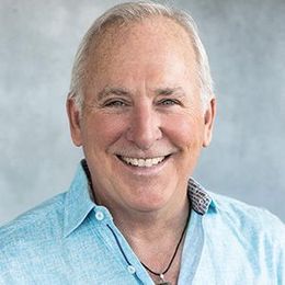 Smiling man in a blue shirt.