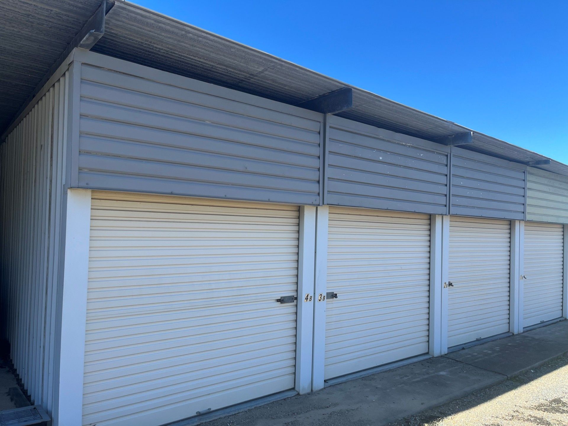 A Shed is Behind a Fence in a Driveway Next to a House — Teralba Business & Storage Park in Teralba, NSW