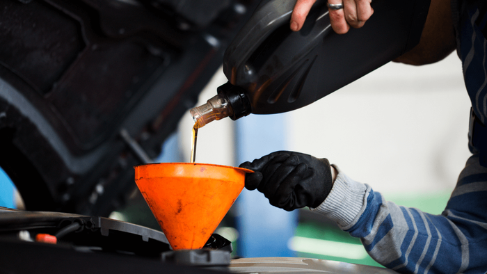 a mechanic doing an oil change