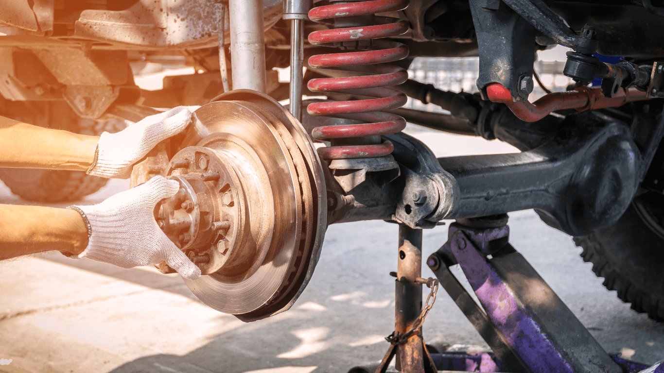 A mechanic doing a suspension repair job