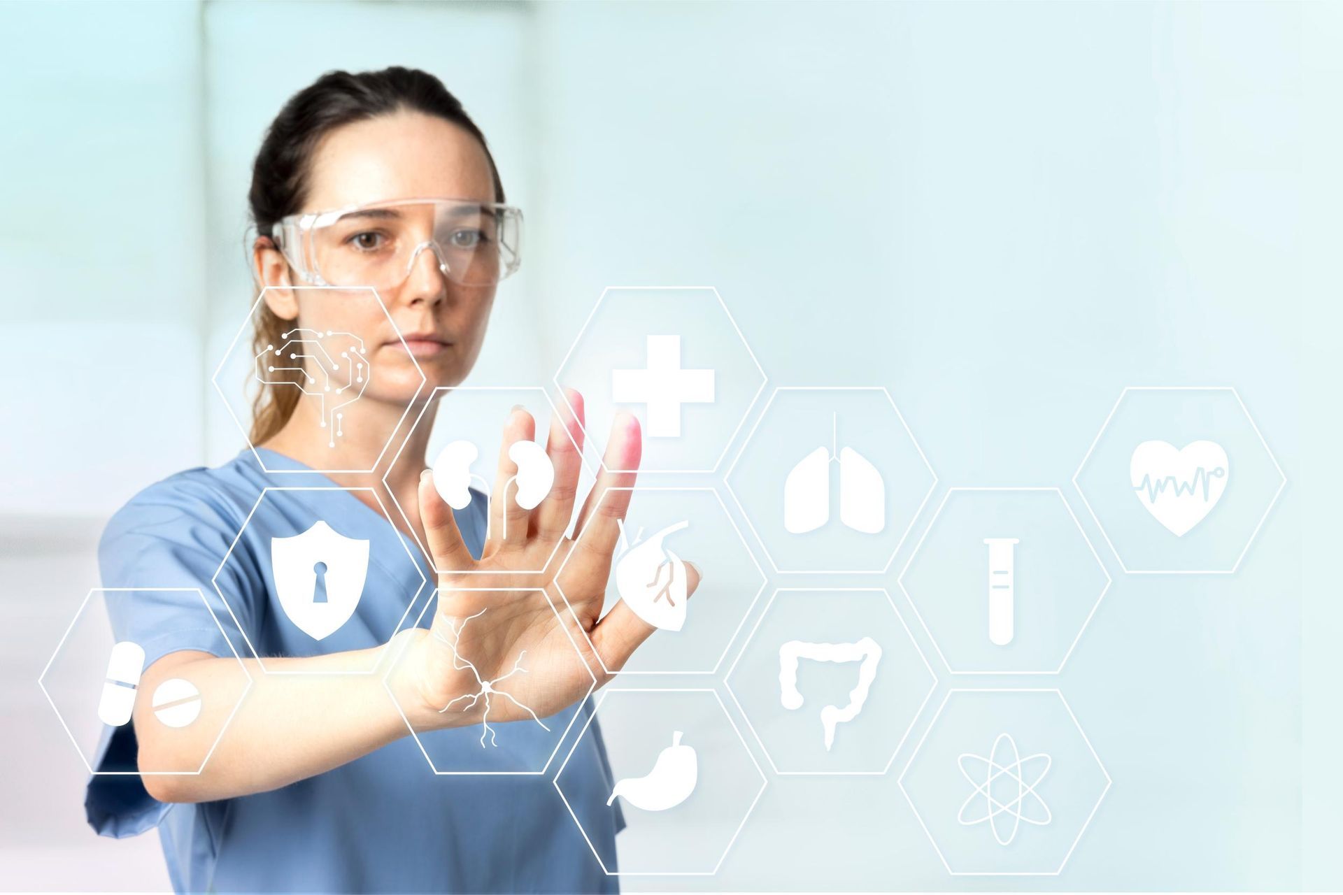 Healthcare worker touching virtual medical icons on a blue background
