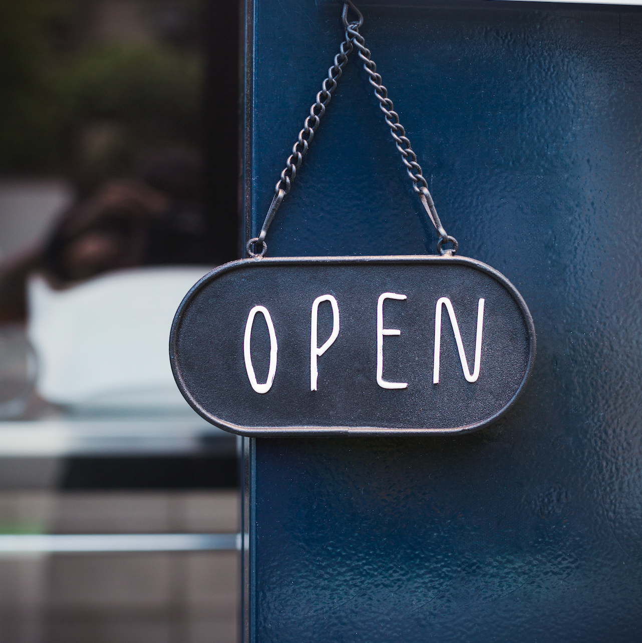 An sign on the front door of a business.