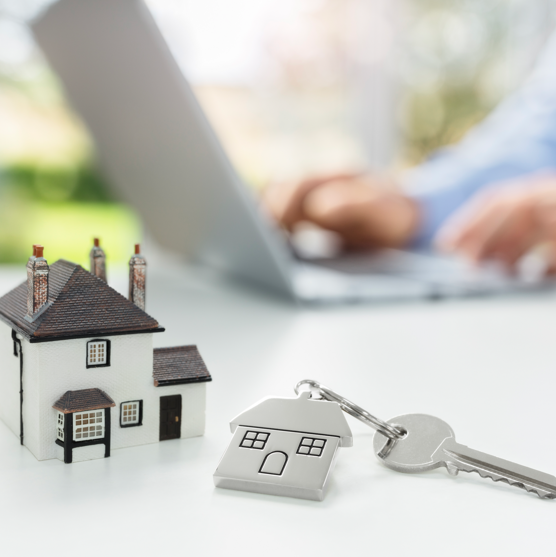 A small house is sitting on a desk.