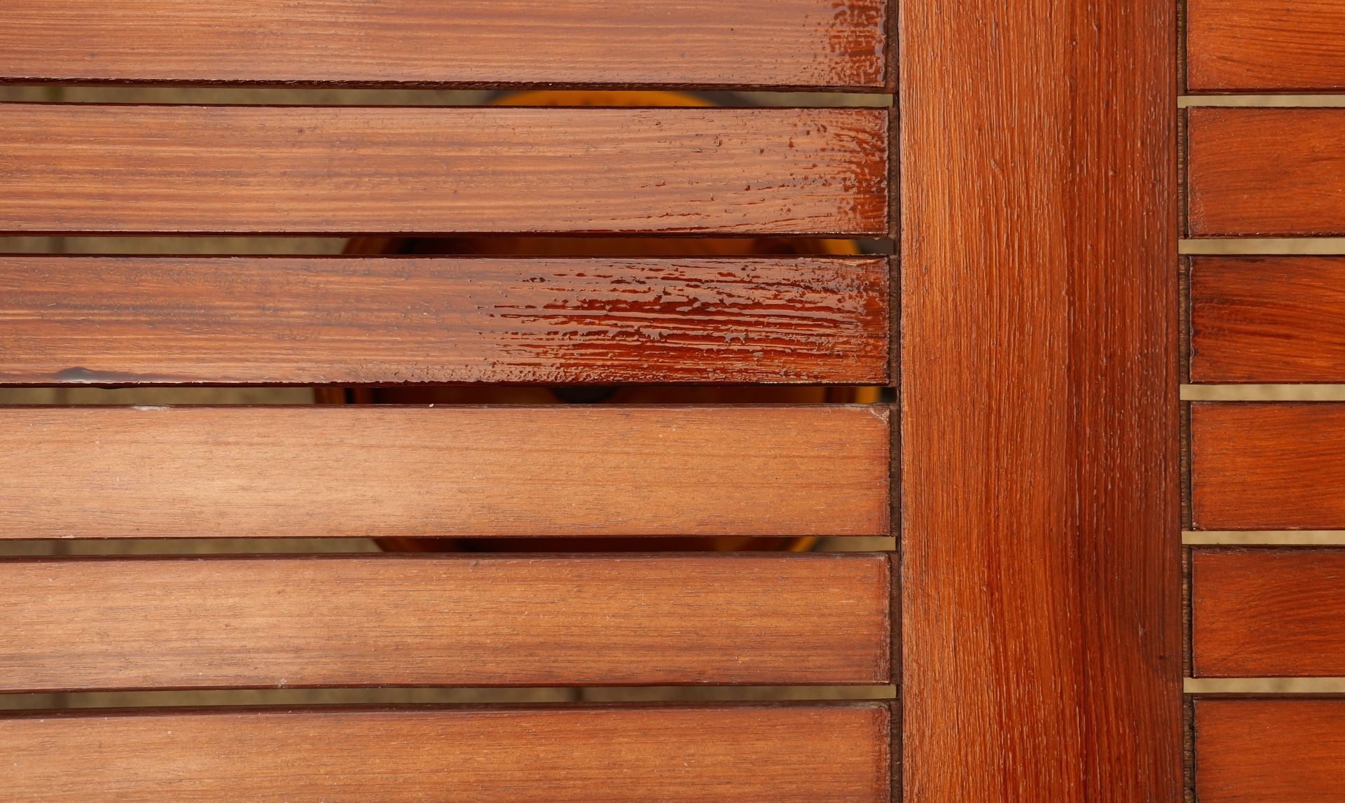 A close up of a wooden table with a stain on it.