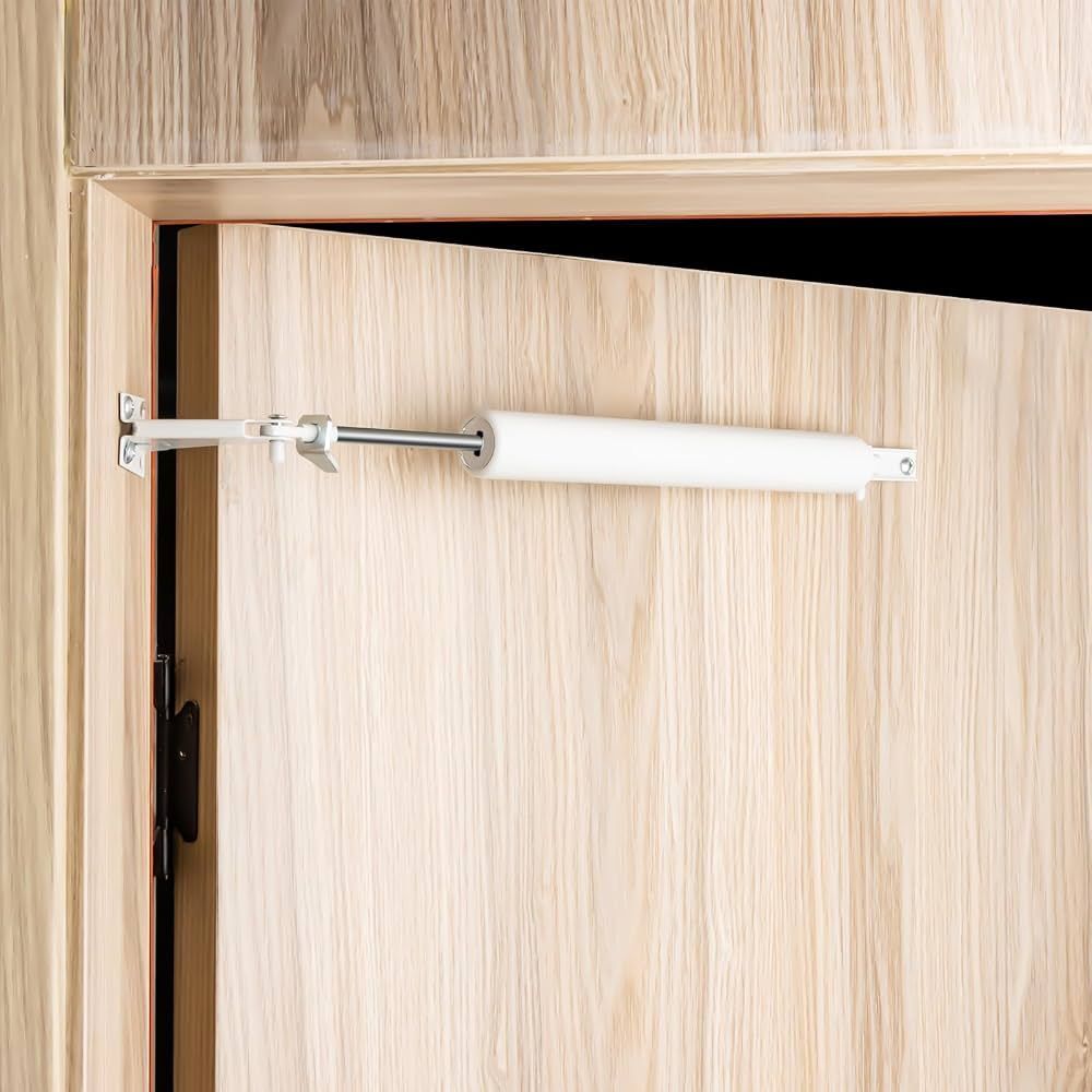 White door security bar latch blocking a partially open wooden door