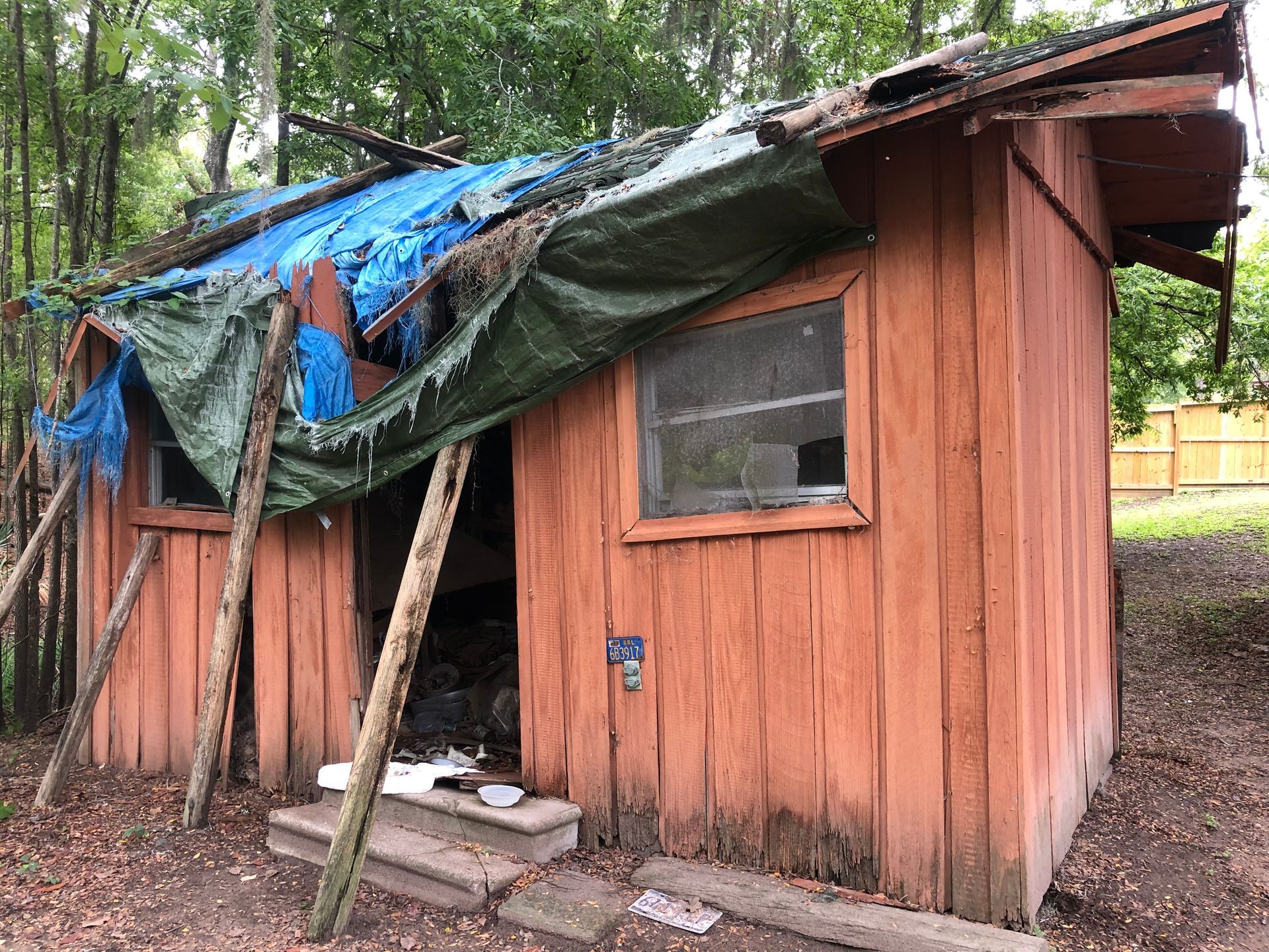 pile of damaged and old furniture in the backyard