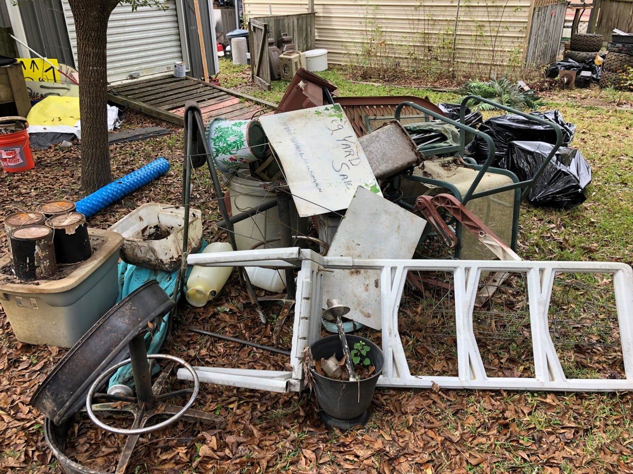 pile of damaged and old furniture in the backyard