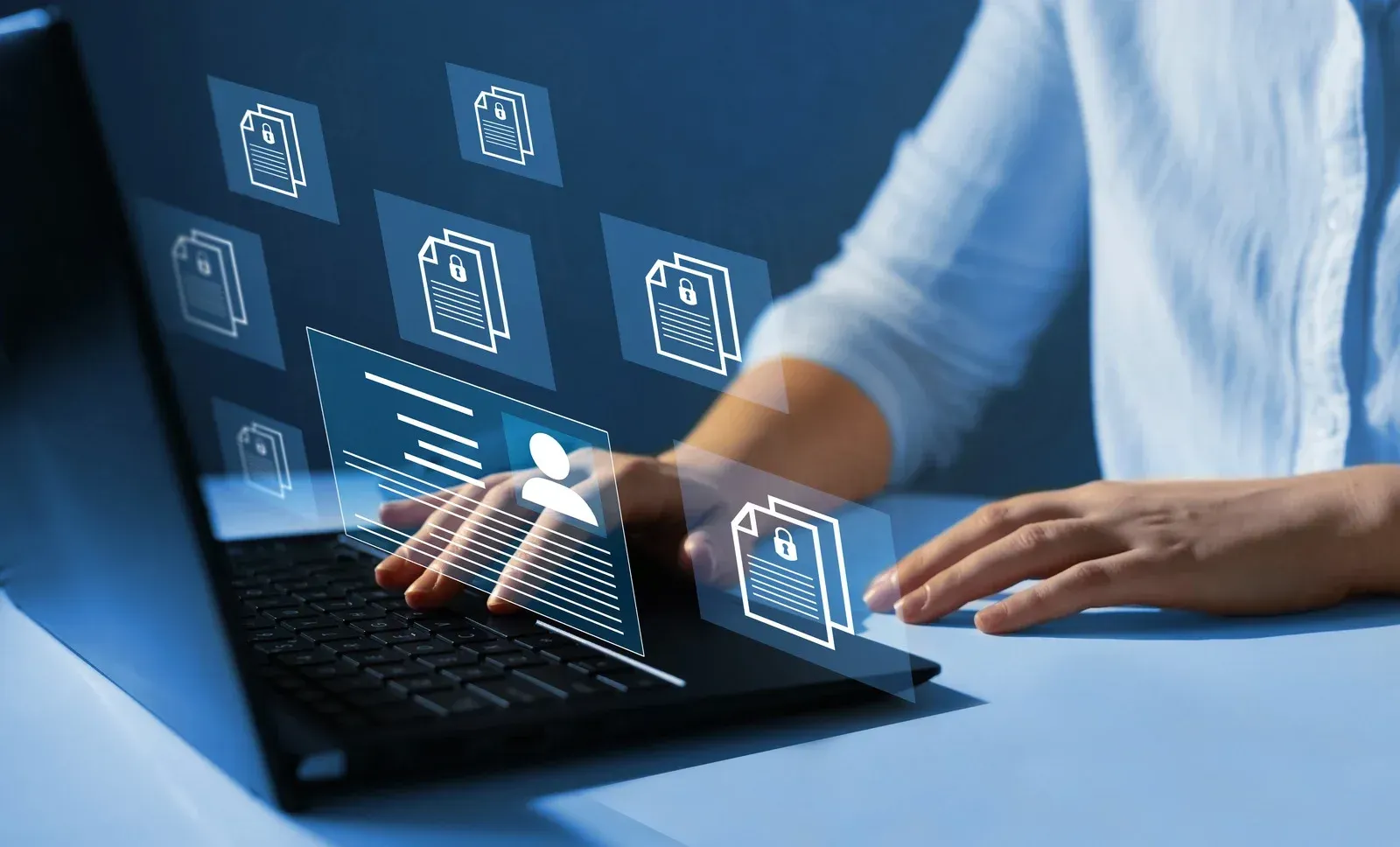 Person typing on a laptop with glowing digital icons overlayed on the screen in a blue office setting