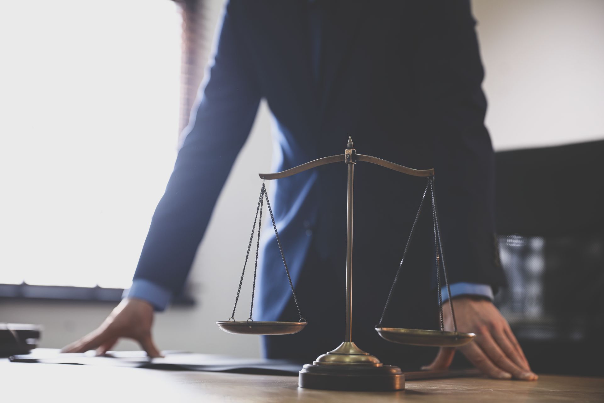 Scales of justice with man in background