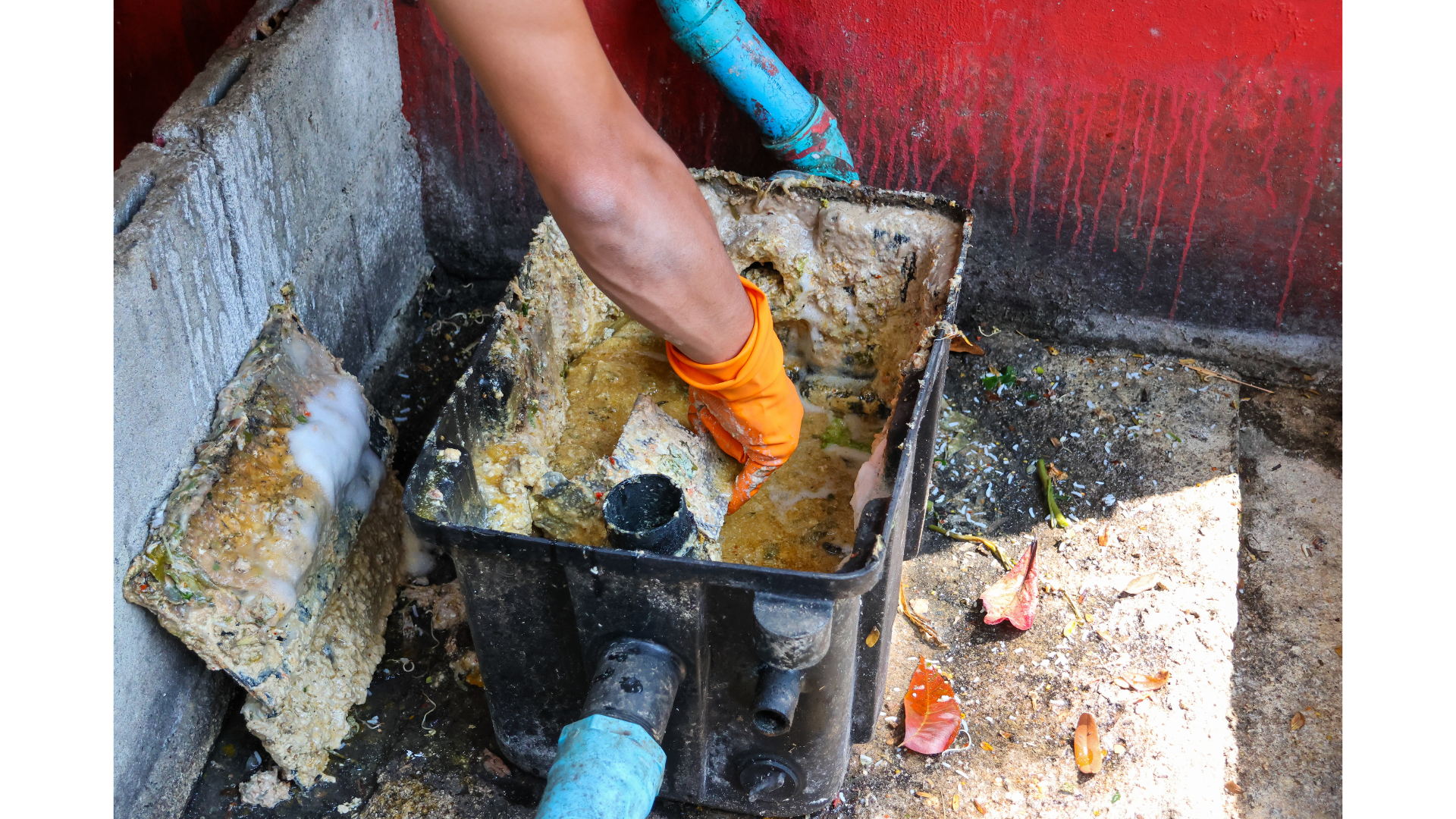 A person is cleaning a drain with a vacuum cleaner.
