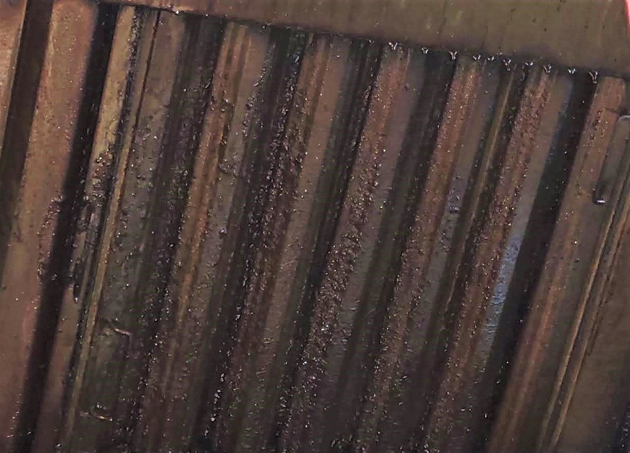 A close up of a wooden door with a lot of stains on it.