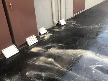 A black floor with a lot of dust on it.