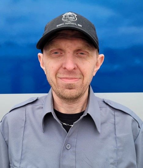 A man wearing a hat with the number 53 on it