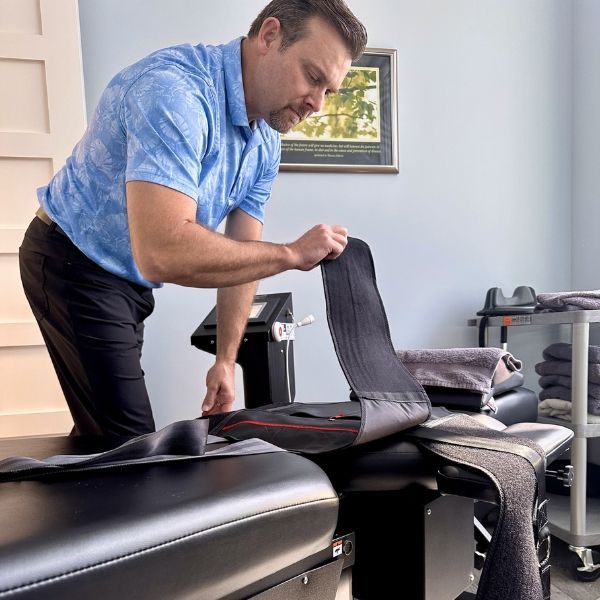 Dr. Matt Murdock setting up a spinal decompression therapy table before treatment