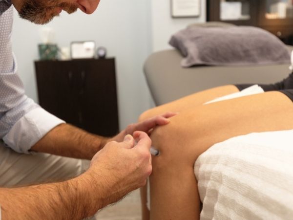 Matt Murdock treating knee pain for patient through peptide therapy injections