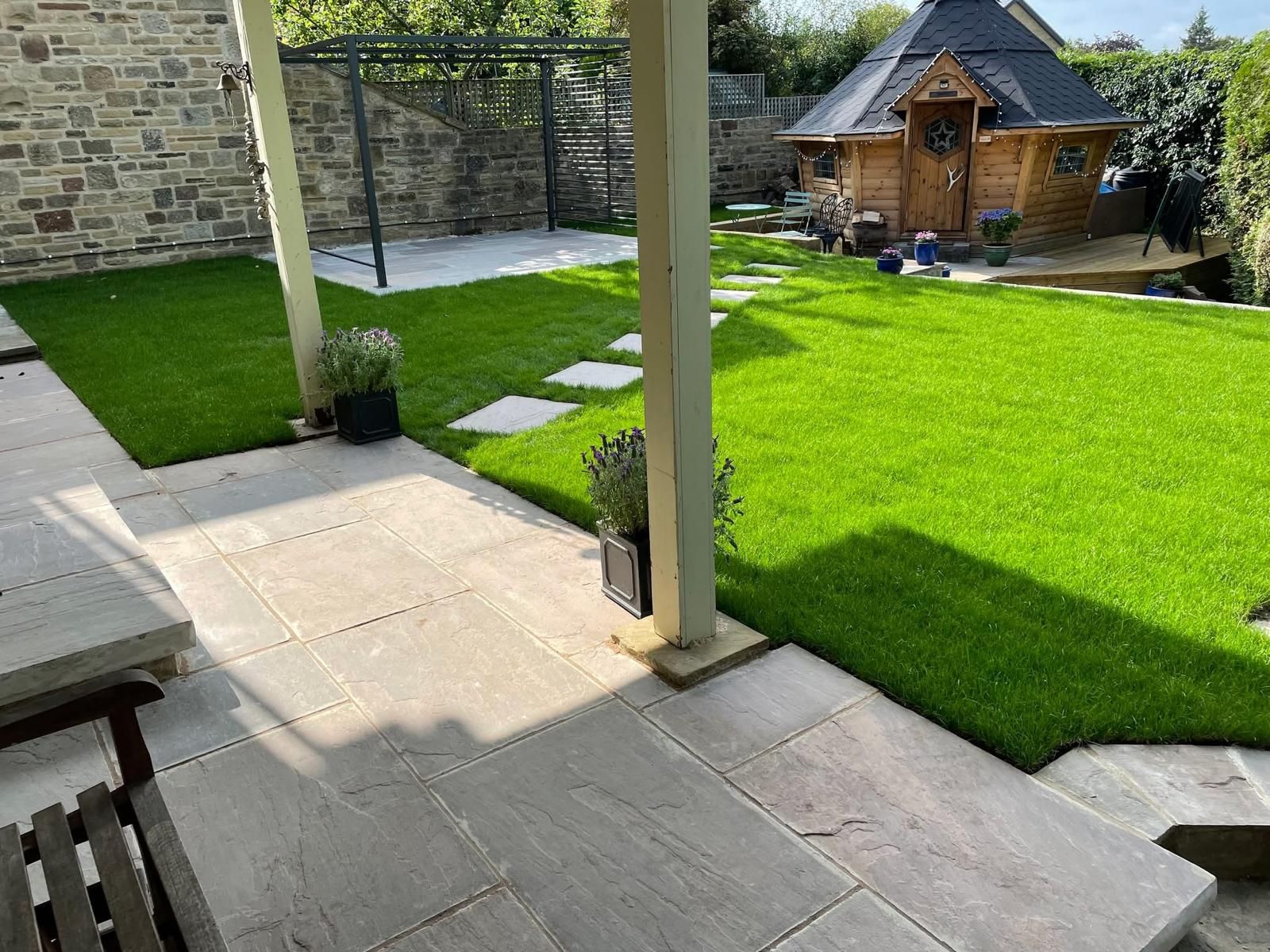 Person spraying lawn with weed killer in front yard.