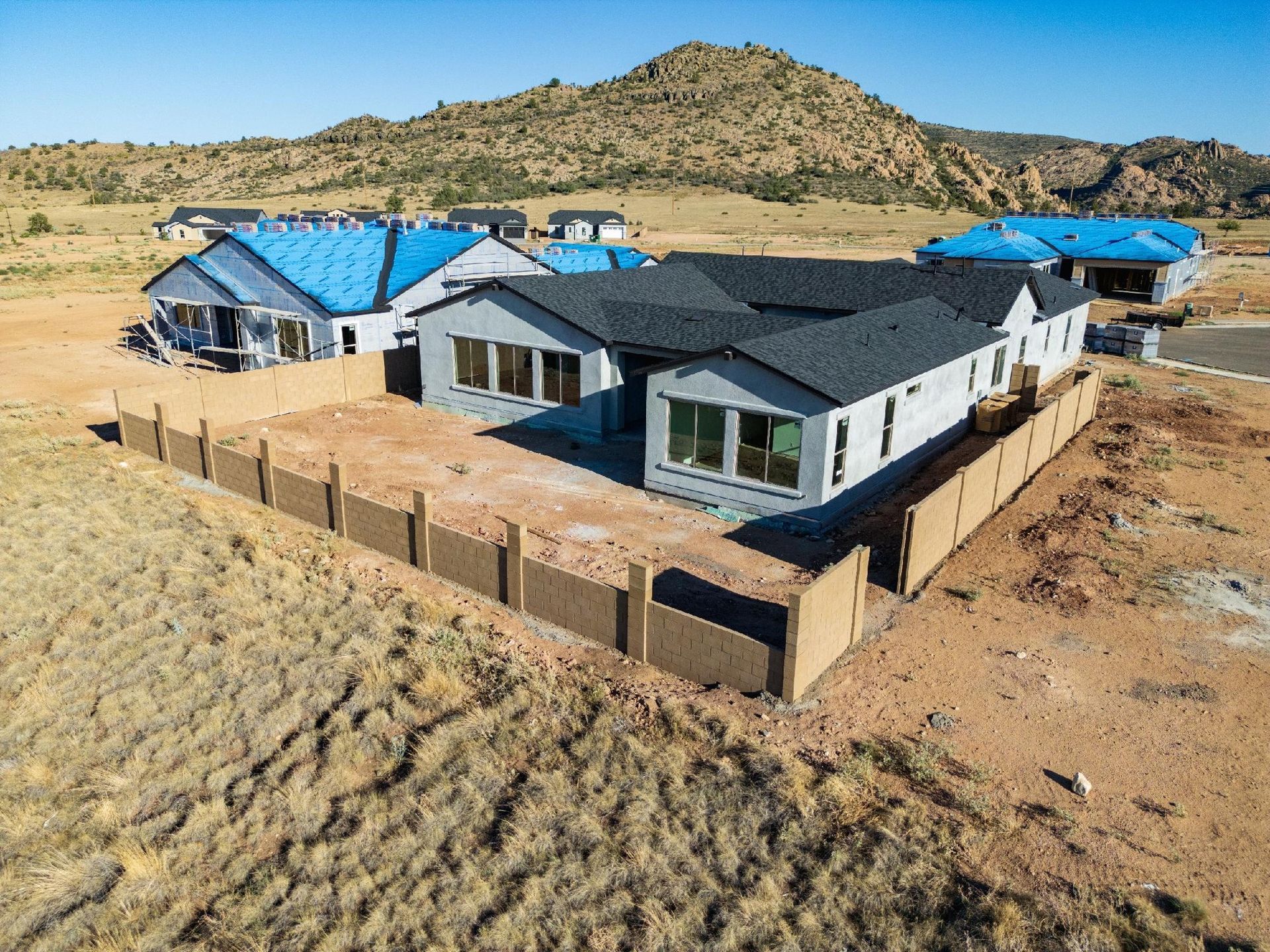 An aerial view of a house with several other homes nearby