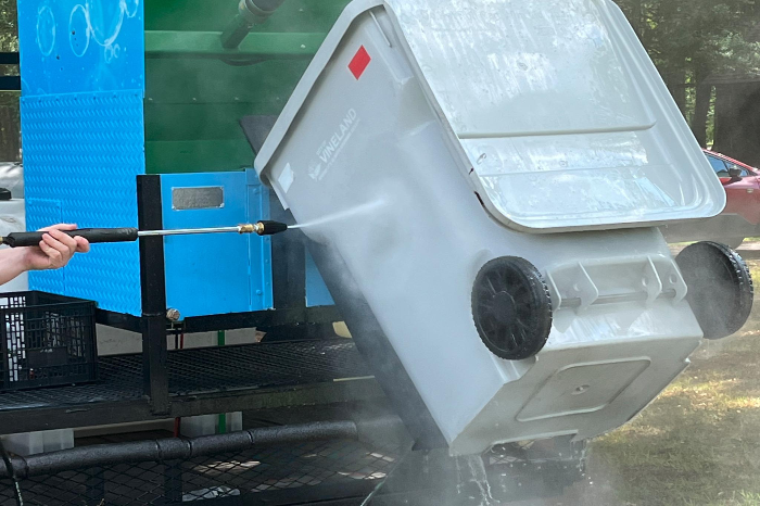 Bin Blitz technician performing curbside trash bin pressure washing in Millville, NJ