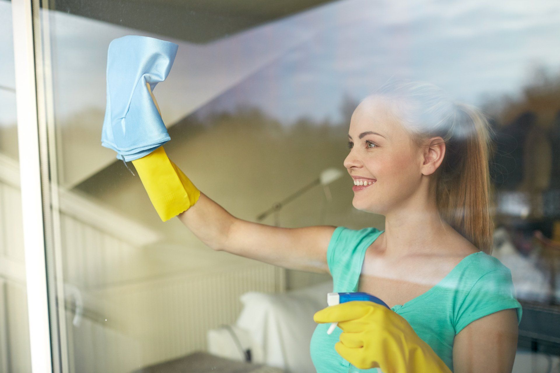 Girl cleaning the window