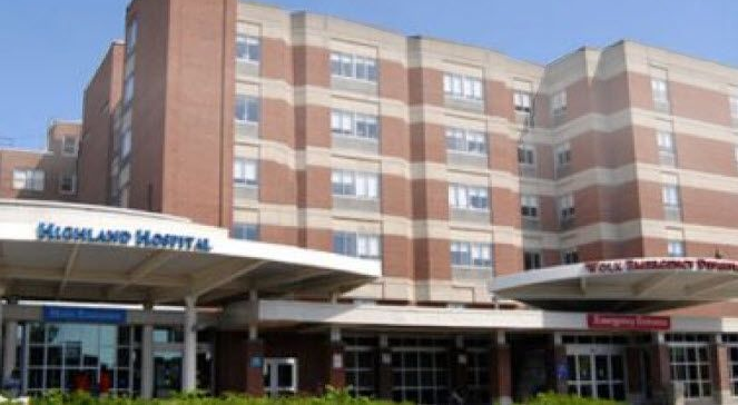 Hospital building exterior with brick facade and entrance canopy