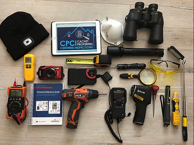 A bunch of tools are laid out on a wooden table