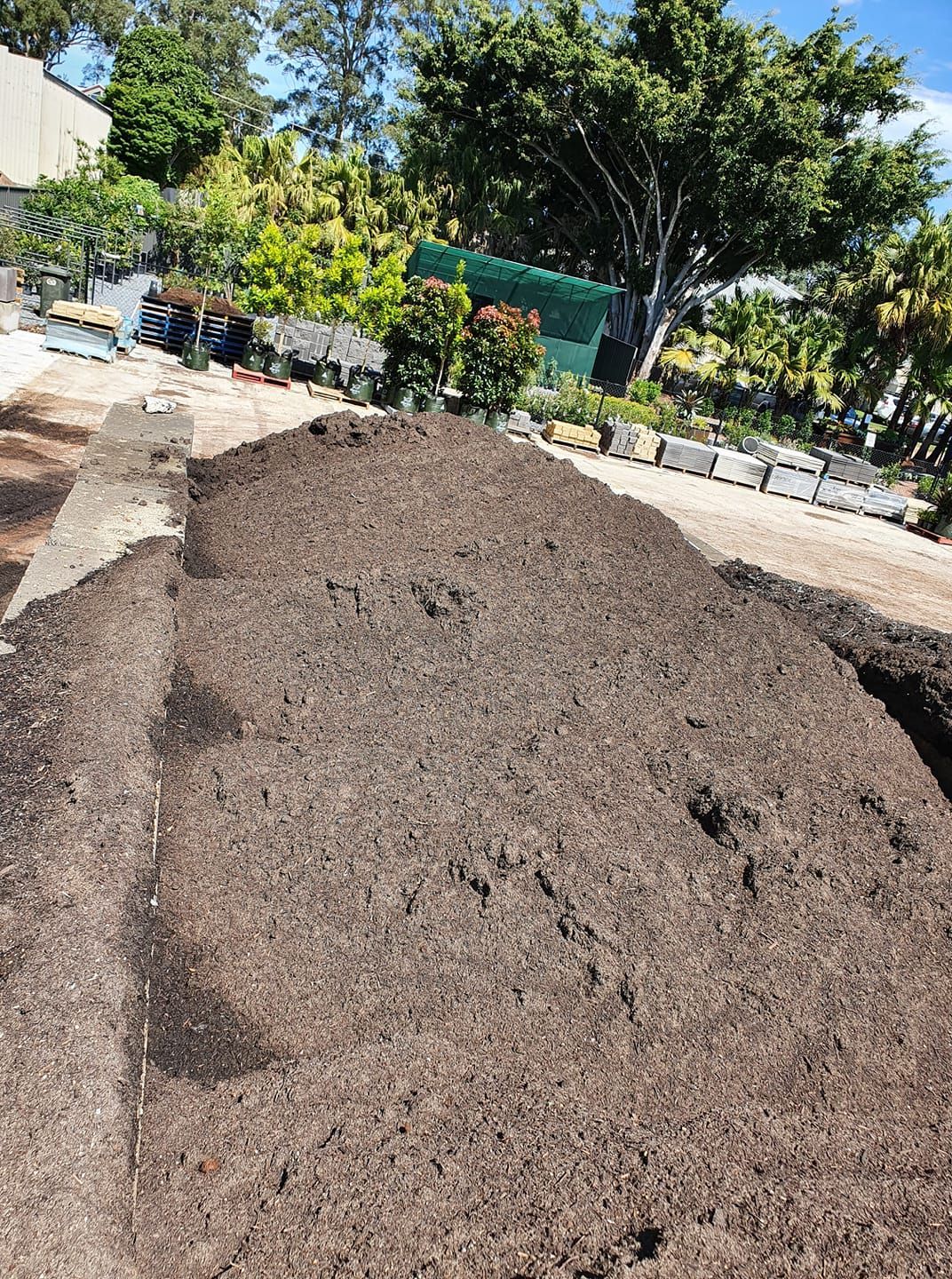 Pile of Dark Soil in A Raised Garden Bed — Port Landscape Supplies in Port Macquarie, NSW