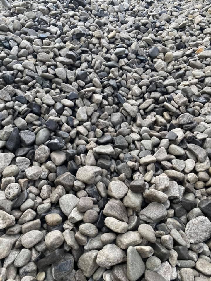 Pile of Smooth, Grey and Black River Rocks — Port Landscape Supplies in Port Macquarie, NSW