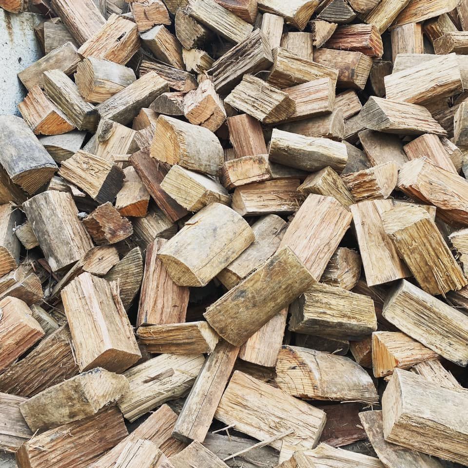 Pile of Split Firewood, Various Lengths and Shades of Brown — Port Landscape Supplies in Port Macquarie, NSW