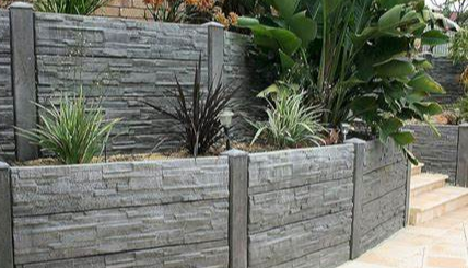 Grey Stone Retaining Wall With Plants — Port Landscape Supplies in Port Macquarie, NSW