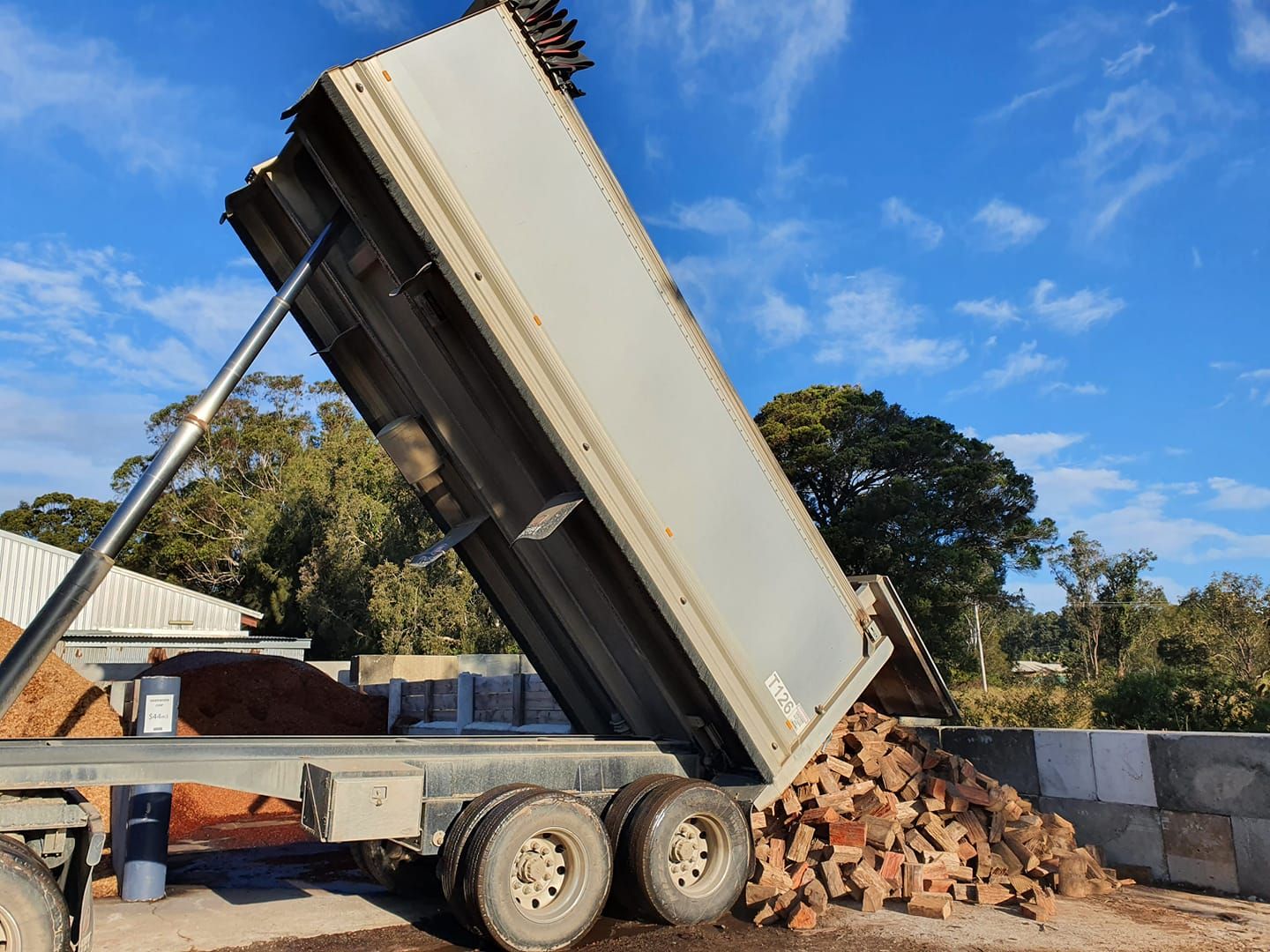 Dump Truck Unloading Bricks Against a Blue Sky — Port Landscape Supplies in Port Macquarie, NSW