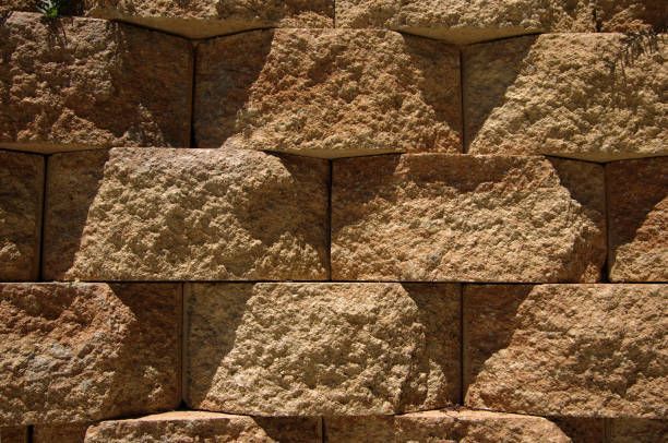Close-Up Of Tan Stone Retaining Wall With Angled Block Pattern — Port Landscape Supplies in Port Macquarie, NSW