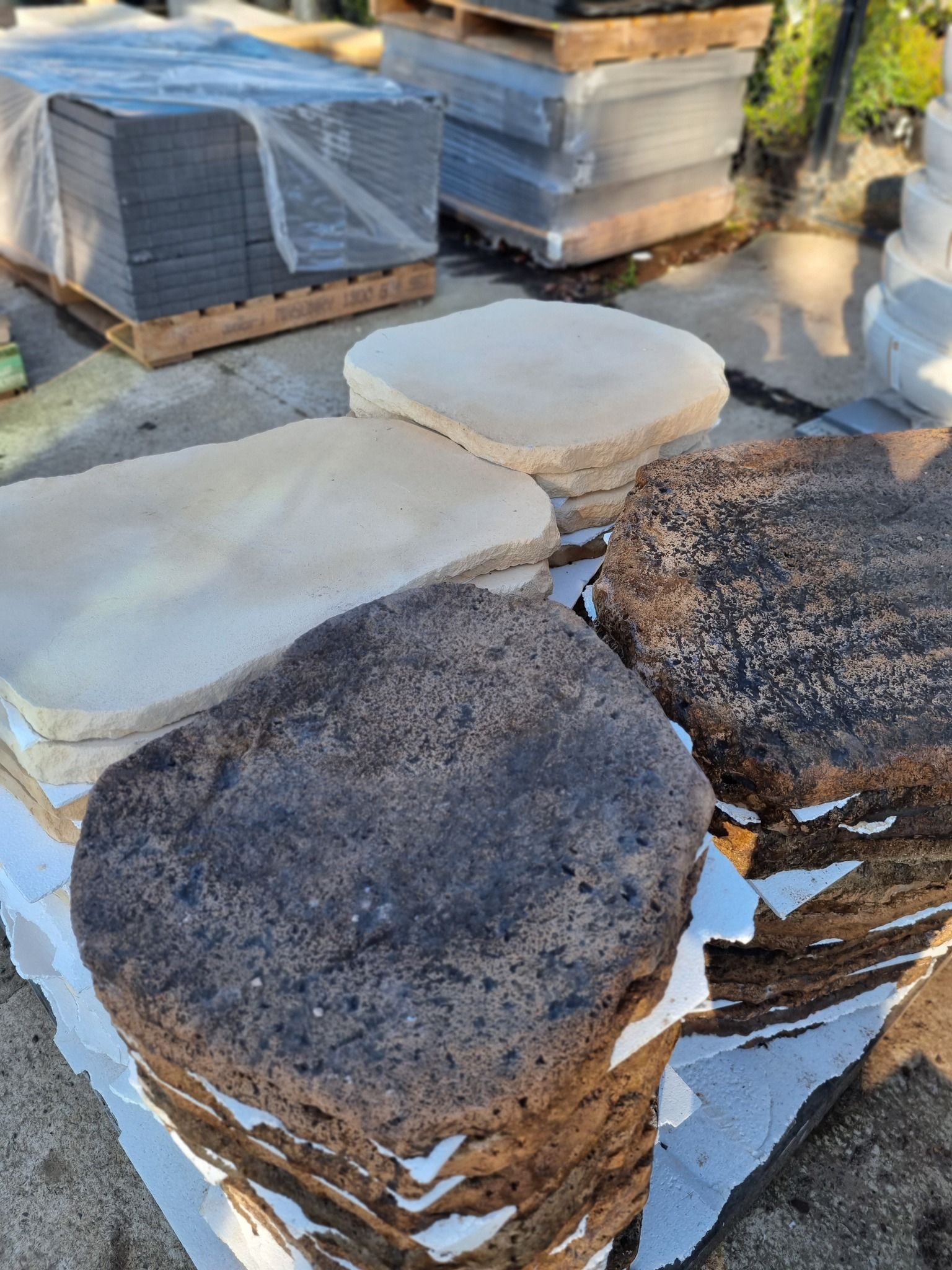Stacks of Tan and Dark Brown Stone Pavers on Pallets — Port Landscape Supplies in Port Macquarie, NSW