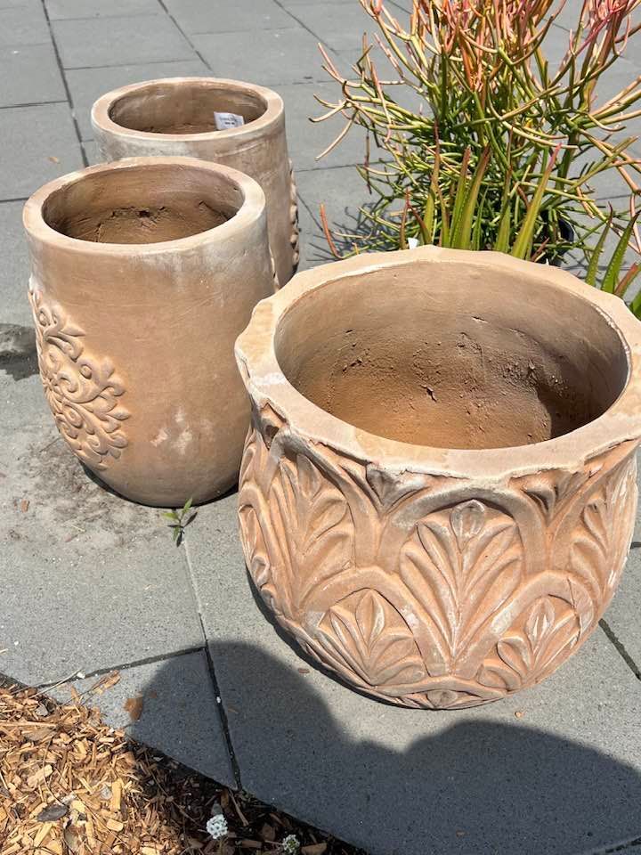 Three Terra Cotta Flower Pots on A Grey Stone Surface — Port Landscape Supplies in Port Macquarie, NSW