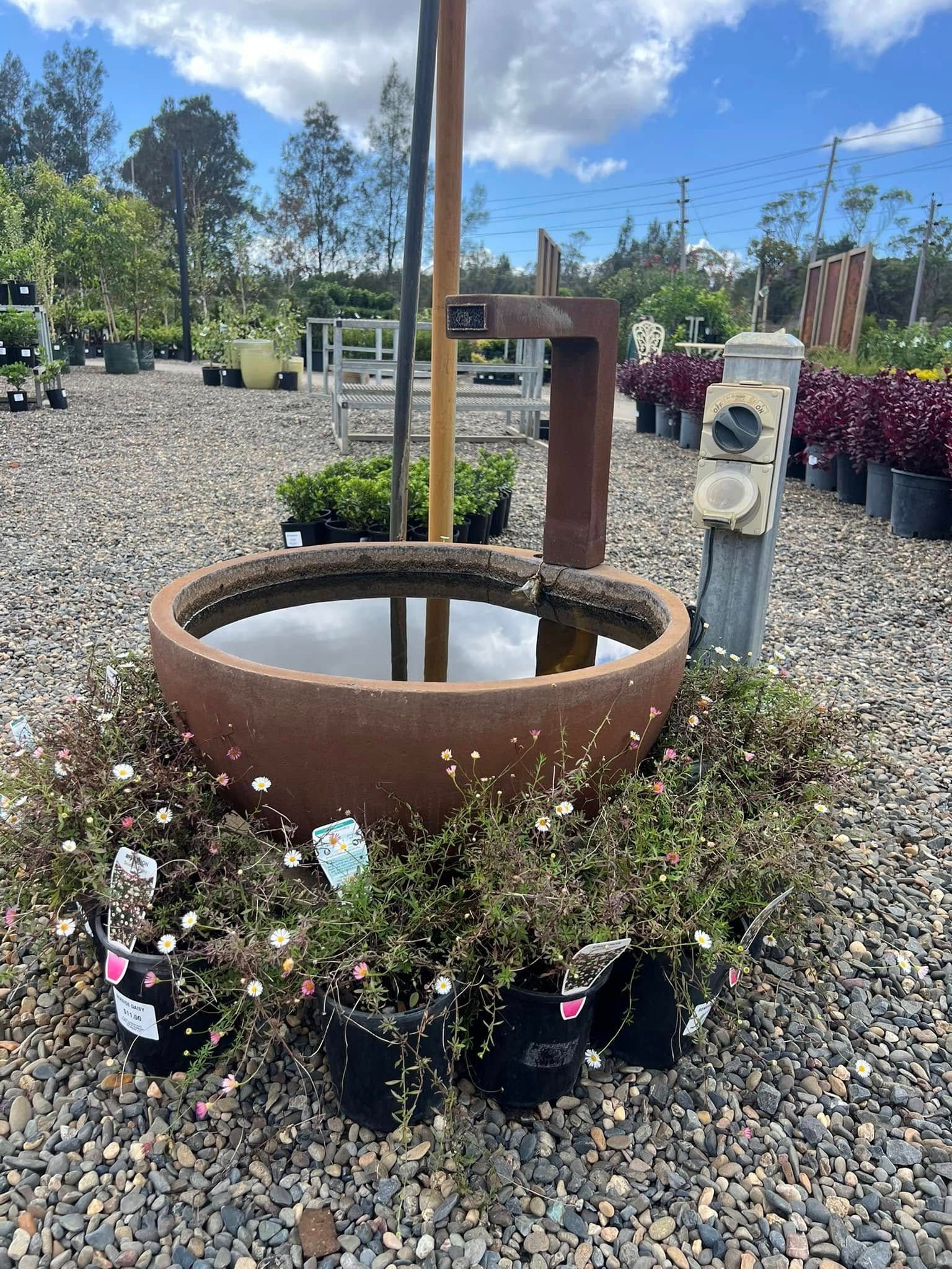 Rusty Water Fountain Surrounded by Potted Plants at A Garden Center — Port Landscape Supplies in Port Macquarie, NSW