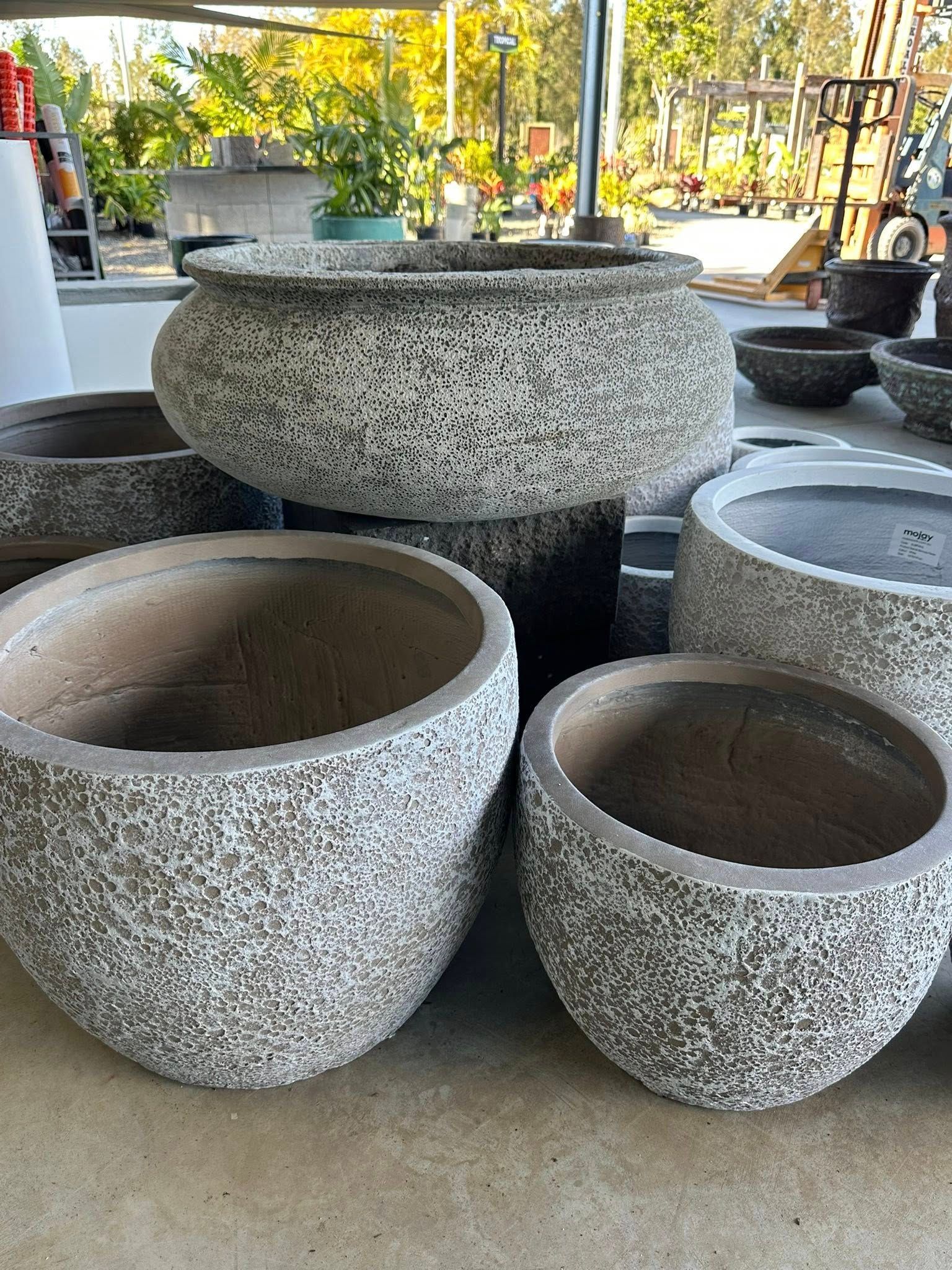 A Collection of Textured Grey and Brown Stone Planters of Various Sizes — Port Landscape Supplies in Port Macquarie, NSW