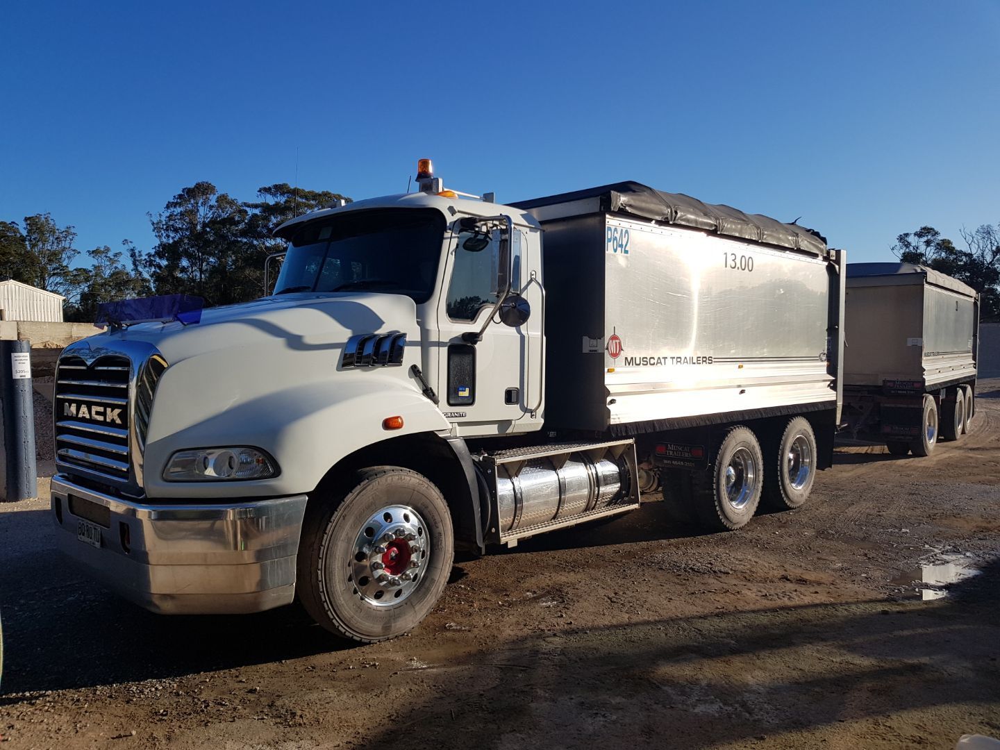 White Mack Dump Truck with Trailer Parked Outdoors on A Sunny Day — Port Landscape Supplies in Port Macquarie, NSW