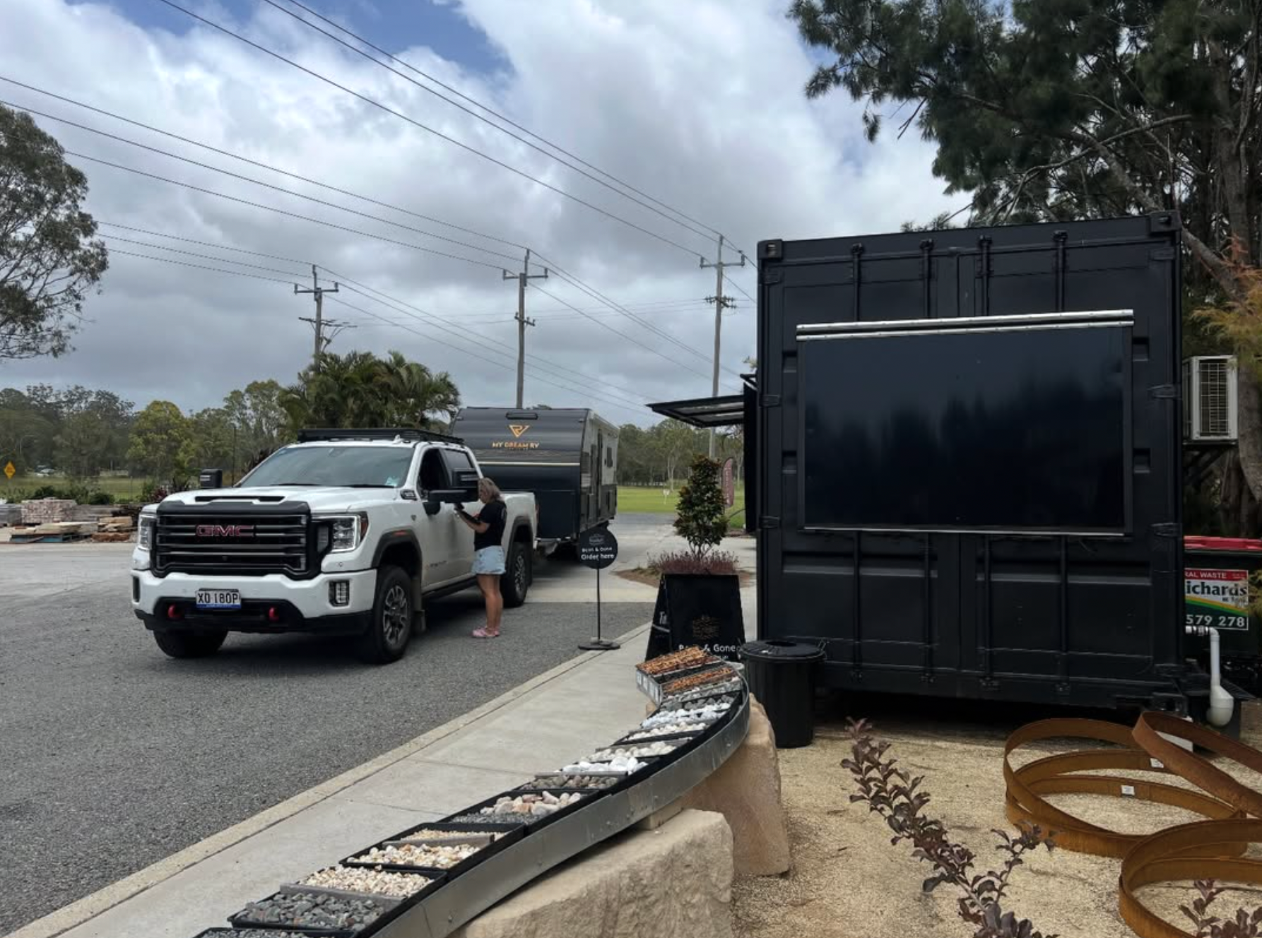 Outdoor Patio Set With Ornate Black Table and Chairs On Brick Pavers — Port Landscape Supplies in Port Macquarie, NSW