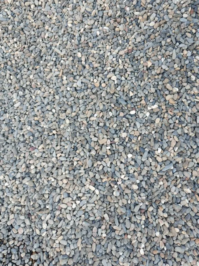 Small Grey and Tan Gravel Stones Covering a Surface — Port Landscape Supplies in Port Macquarie, NSW