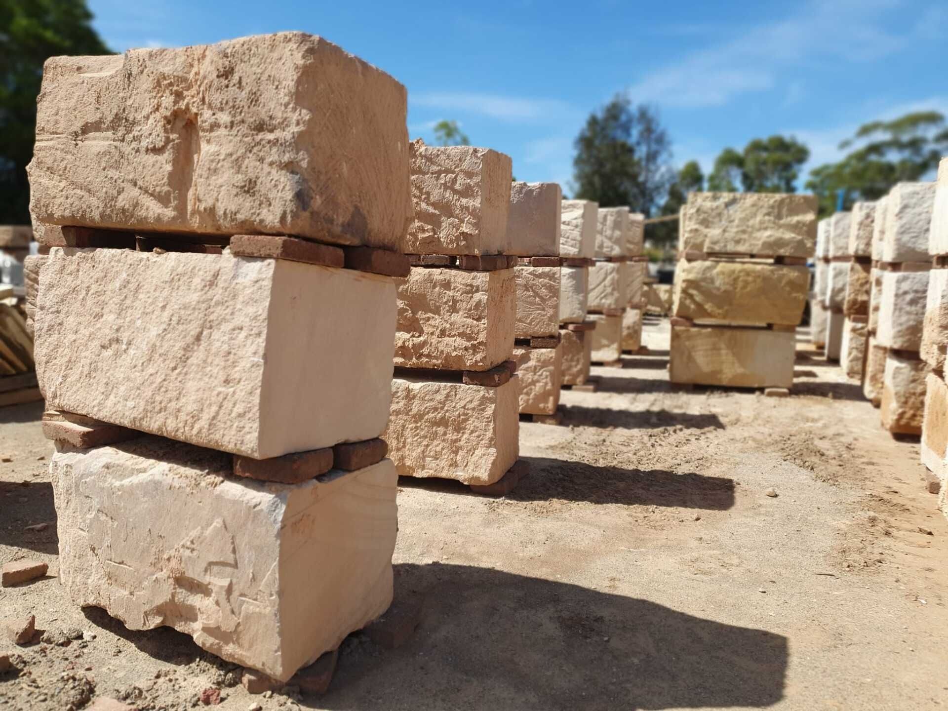 Stacks Of Beige Sandstone Blocks With Rough and Smooth Surfaces — Port Landscape Supplies in Port Macquarie, NSW