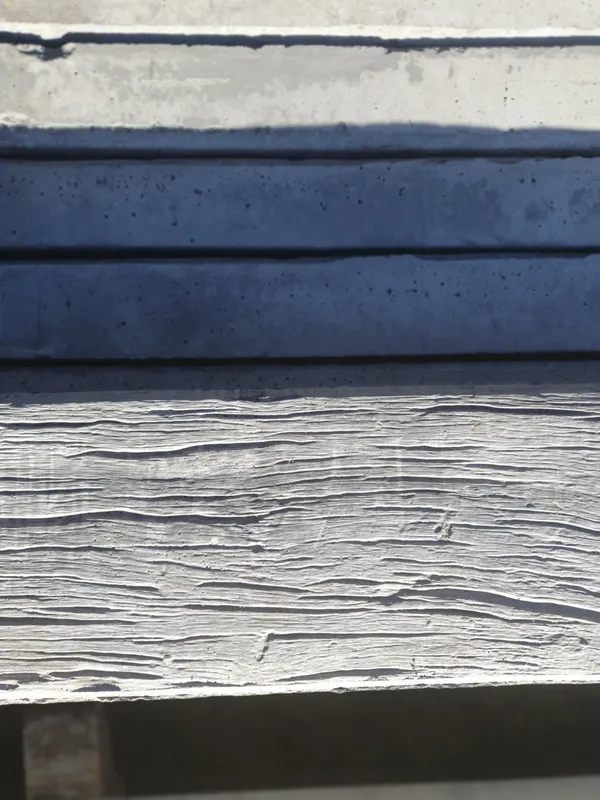 Stack of Grey Concrete Slabs and Weathered, Light Wood — Port Landscape Supplies in Port Macquarie, NSW