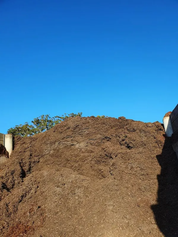 Pile of Brown Mulch Under a Clear, Blue Sky — Port Landscape Supplies in Port Macquarie, NSW