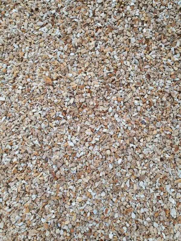 Close-up of small beige, white, and tan gravel stones covering the ground